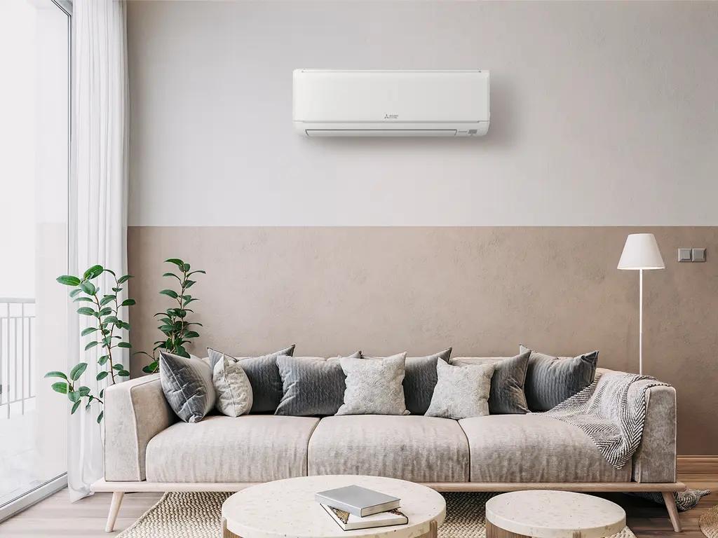 Wall-mounted ductless mini split above a sofa in a modern living room — best DIY mini split brands 2026